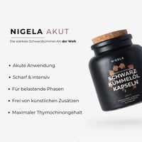 Nigela Akut Schwarzkümmelöl Kapseln mit Nigellin®️ – schwarze matte Dose mit Korkverschluss, Nigella sativa Blüte und Lavagestein